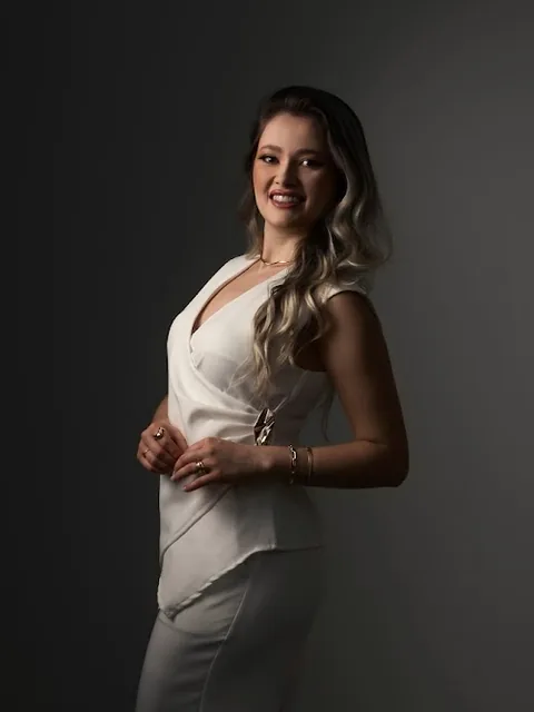 Retrato da Luciana de branco, em fundo escuro